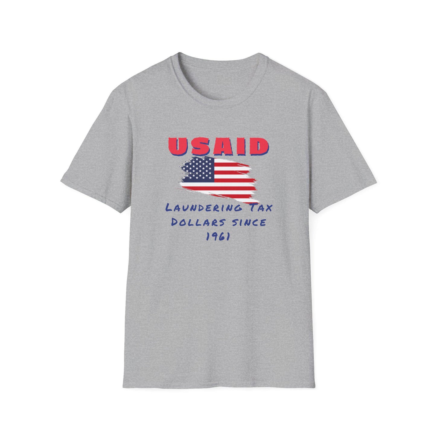 A heather gray T-shirt is displayed flat against a white background. The front of the shirt features a distressed American flag graphic in the center. Above the flag, bold red letters spell out &quot;USAID.&quot; Below the flag, blue handwritten-style text reads: &quot;Laundering Tax Dollars Since 1961.&quot; The design conveys a satirical political message with a protest-style aesthetic.