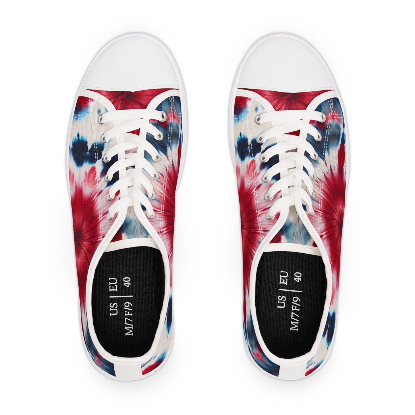 Top view of a pair of low-top canvas sneakers featuring a vibrant red, white, and blue tie-dye design. The shoes have white laces, white rubber toe caps, and insoles marked with the size “US M7/F9” and “EU 40.” The energetic, patriotic pattern makes them perfect for summer festivities or casual wear with a bold twist.
