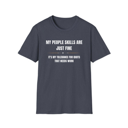 Dark heather navy unisex T-shirt displayed flat on a white background, featuring bold white and gold text that reads: “MY PEOPLE SKILLS ARE JUST FINE — IT’S MY TOLERANCE FOR IDIOTS THAT NEEDS WORK.” A small decorative line with diamond accents separates the two text sections.