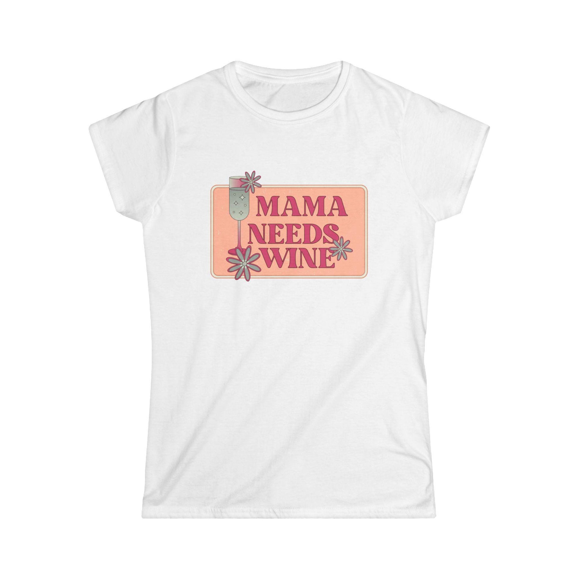 White women&#39;s fitted t-shirt featuring a playful retro-style graphic with the phrase &quot;Mama Needs Wine&quot; in bold pink letters on a soft peach rectangular background. The design includes daisy flower accents and a tall champagne glass illustration, giving it a fun and relaxed vibe. Shirt is displayed on a plain white background.